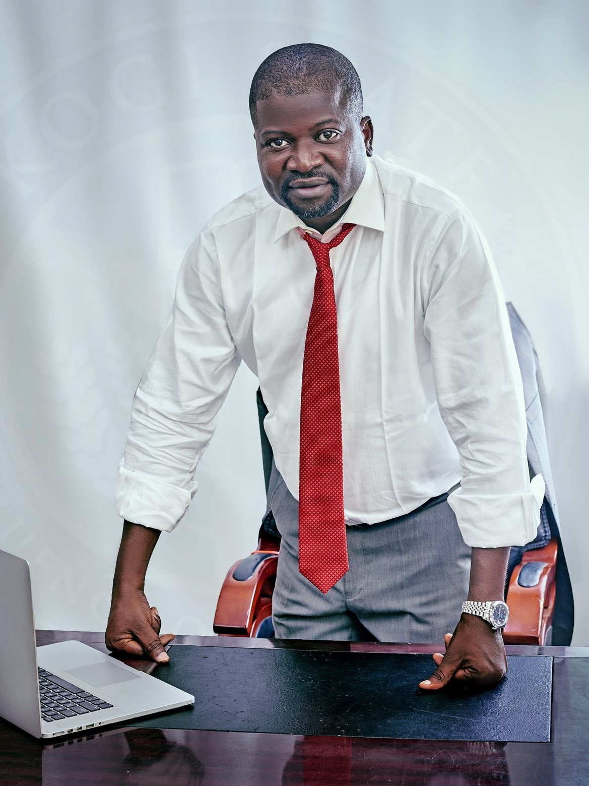 Asiwaju Asiru Idris standing at his desk